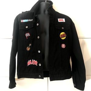 Black distressed denim jacket with patches